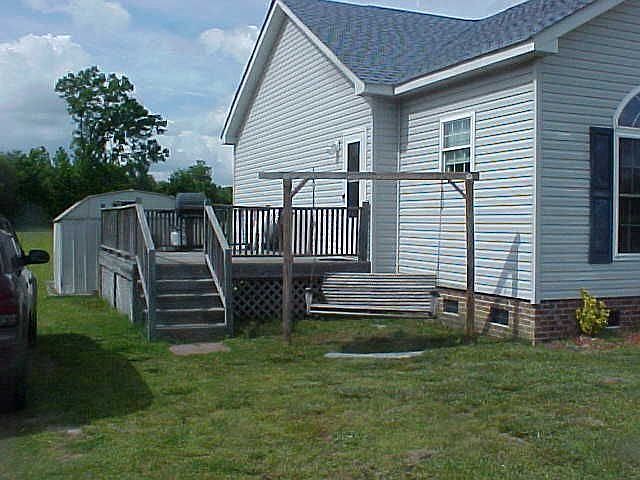 The end of the home has a large wooden deck.