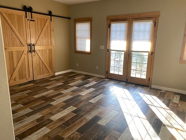Main room showing tenant barndoor lock off to resident''s basement area