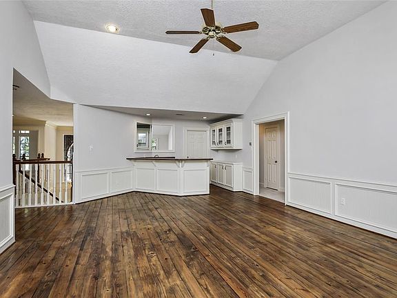 Huge game room up with wet bar and wood floors! hallway on either side and both and 2 bedrooms off each hallway!