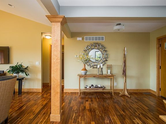 Acacia (Asian Walnut) hardwood floors are found throughout the foyer, great room, dining room, and kitchen.
