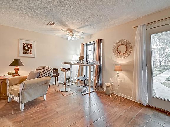 CURRENTLY A HOME WORK SPACE, THIS AREA CAN EASILY BE DESIGNED TO BE ADDED LIVING ROOM SPACE.