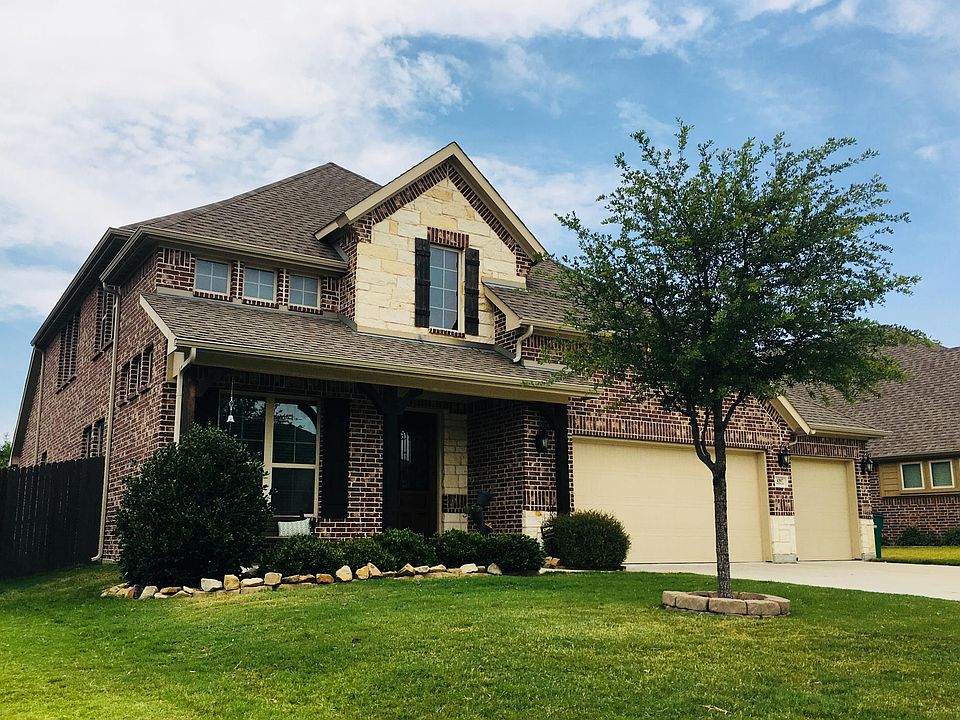 Front elevation features an inviting patio with room for sea