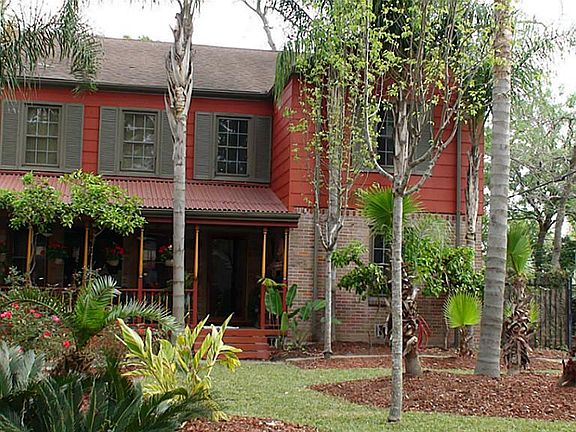 Home is surrounded by a lushly landscaped lawn with numerous fruit trees, along with 5 pecan trees o