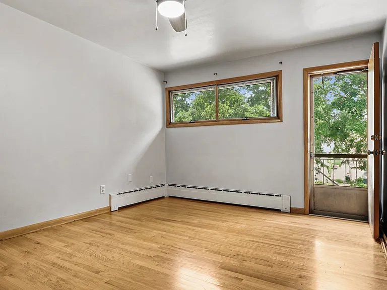 This bedroom also has a new ceiling fan and beautiful hardwoods - plus a little patio!