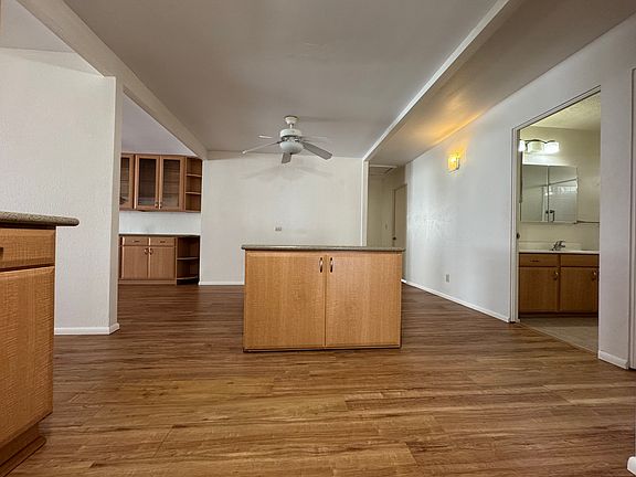 Movable island. Viewing from the kitchen, the 3 bedrooms and 2 bathrooms are on the right.