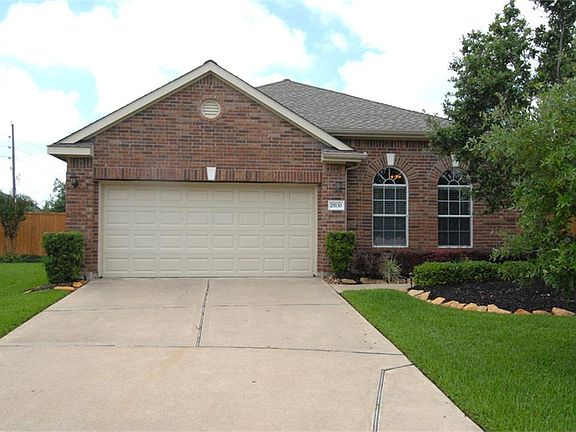 Another front view showing the double wide garage and driveway