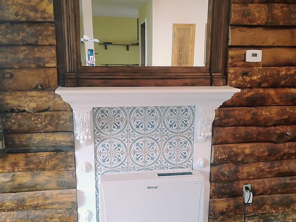 Furnace and mantel in the living room.