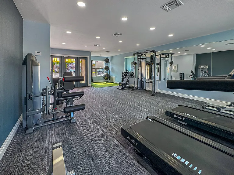 Modern fitness center with treadmills, weights, and more at Borders Apartments Brownsville TX.