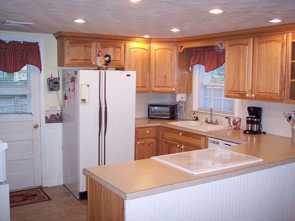 Remodeled Kitchen with wood cabinets. Appliances remain