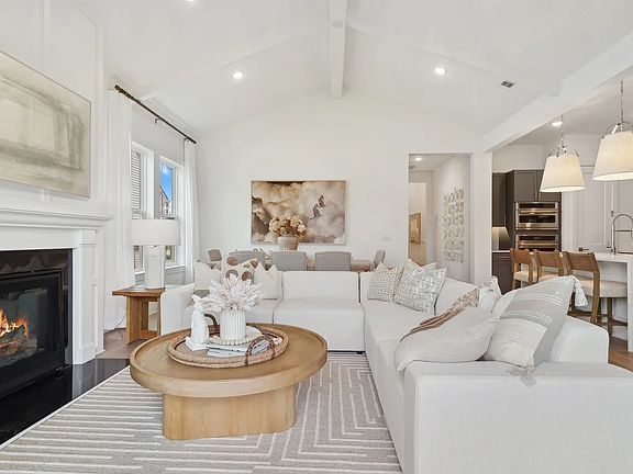 Great room with vaulted ceiling and white painted ceiling beams
