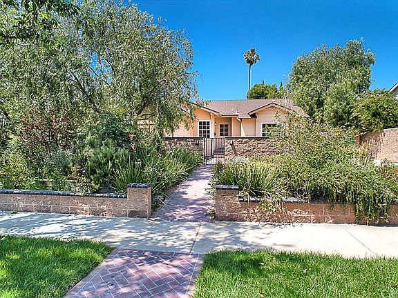 The handsome curb appeal with mature landscaping a
