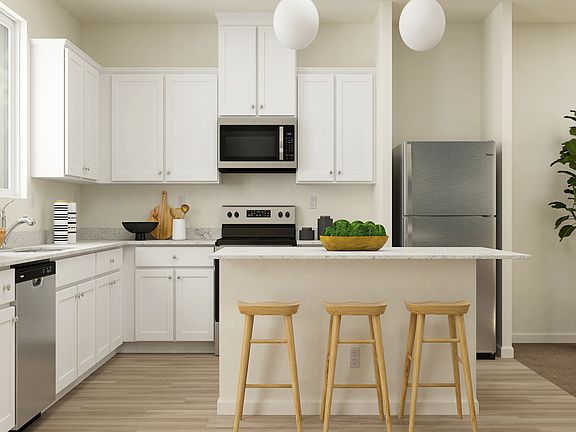 This kitchen includes a full suite of stainless appliances by Whirlpool.