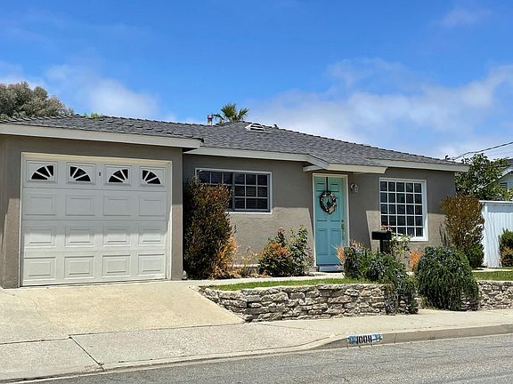 View of house front, including single car garage.