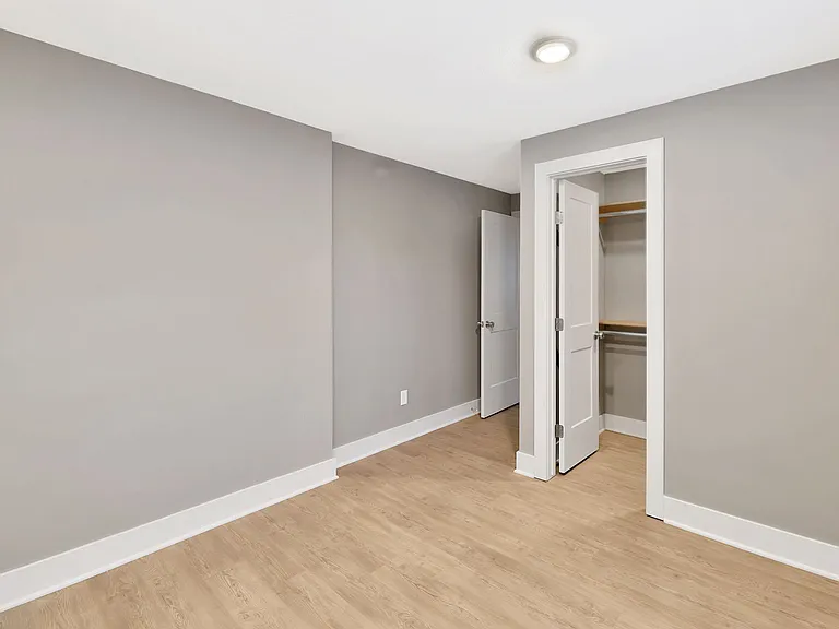 5th bedroom in lower level with walk in closet and view out window