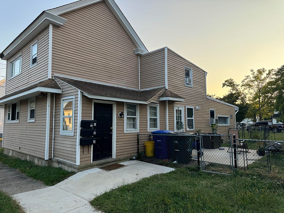 main entrance to the left, next to mailbox. 2nd door in the yard
