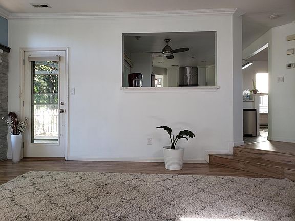 Living Room to Kitchen view and Door to Deck