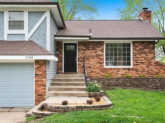 Stone paver landscaping beds added with fresh plantings.