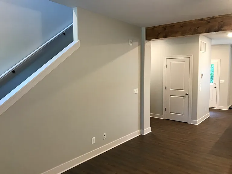 Living room showing 2nd floor stairs to 2 bedrooms.