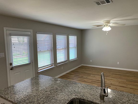 Kitchen overlooks family room and out to large all grass back yard