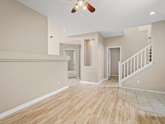 dining looking to stairs and powder room