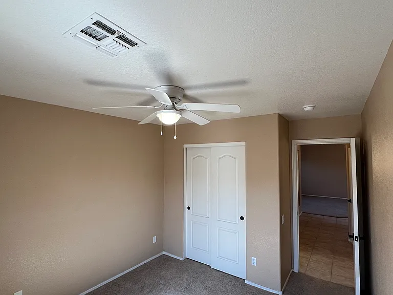 bedroom on first floor next to a full bathroom both on first floor