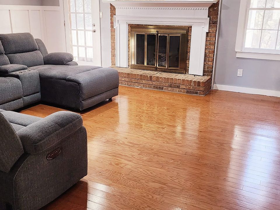 Living room with brick fireplace. Living room opens out to the deck.