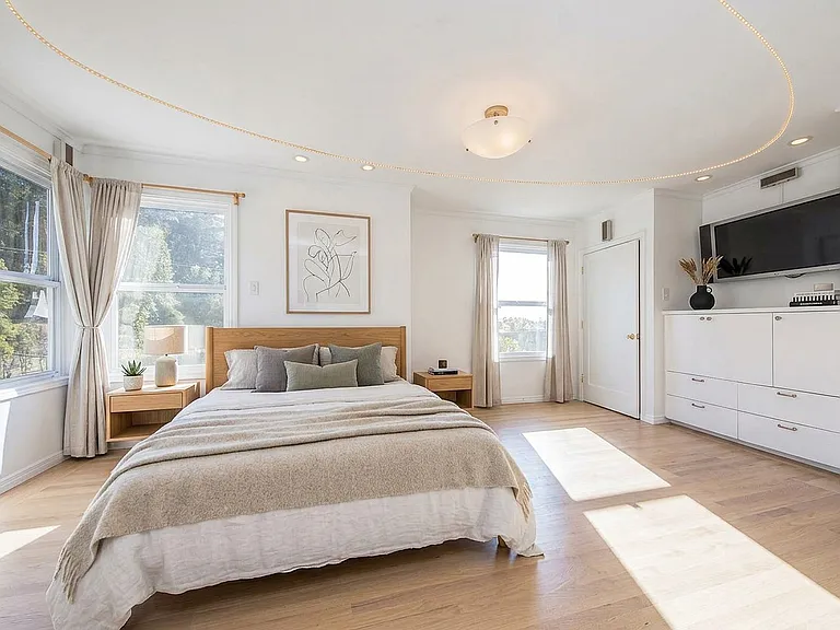 Master suite bedroom on 2nd floor overlooking garden, with two large closets and built in cabinets in room pictured, plus a walk in closet area with two additional closets and vanity desk area with window connecting to master bathroom. Styled with ai.