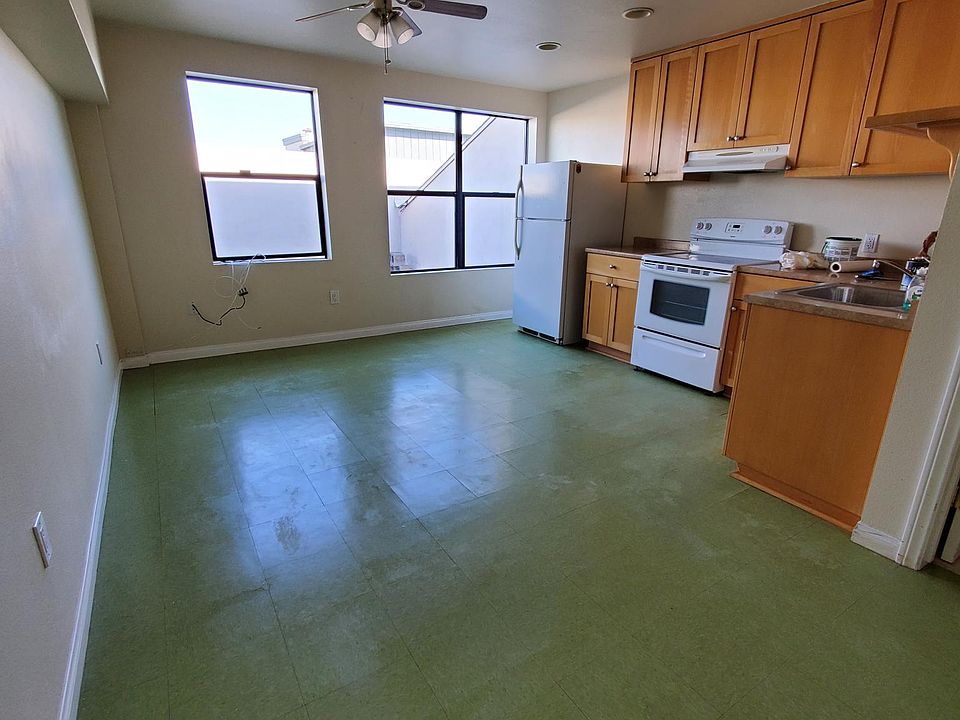 Main room with stove and refrigerator included
