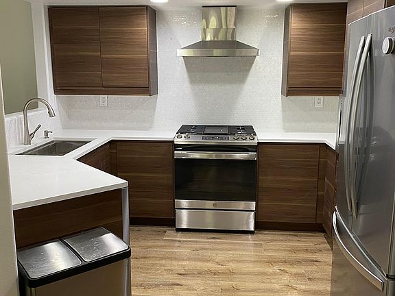 Beautifully remodeled kitchen with quartz countertops & stainless appliances & farm sink!