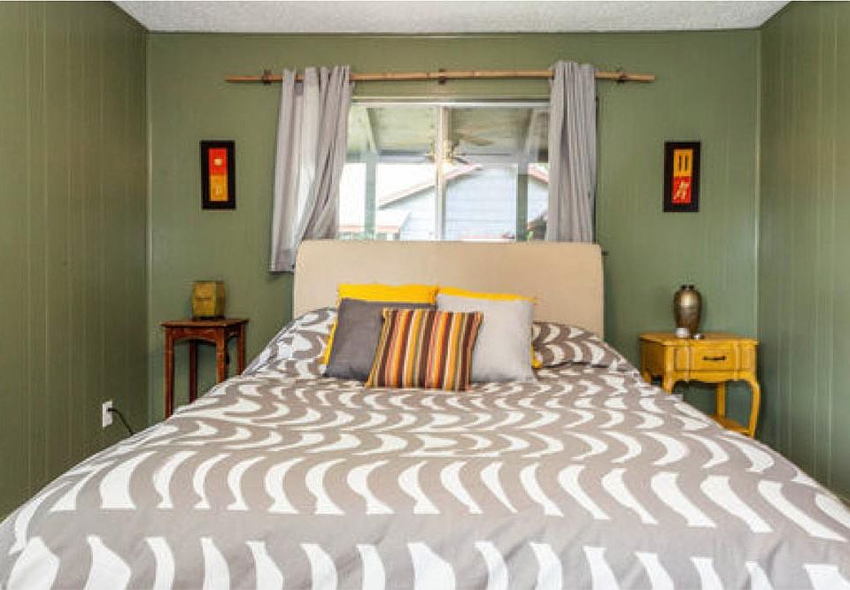 Bedroom with king bed. Walls recently painted white.