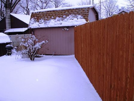 Backyard with storage barn with power