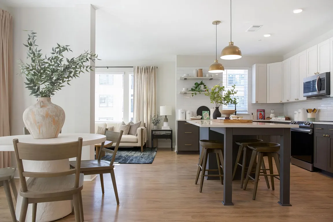 Picturesque open kitchen area with modern island and charcoal color cabinets