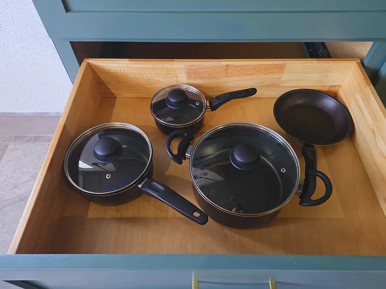 Pots with lids and pans included for easy home cooking.