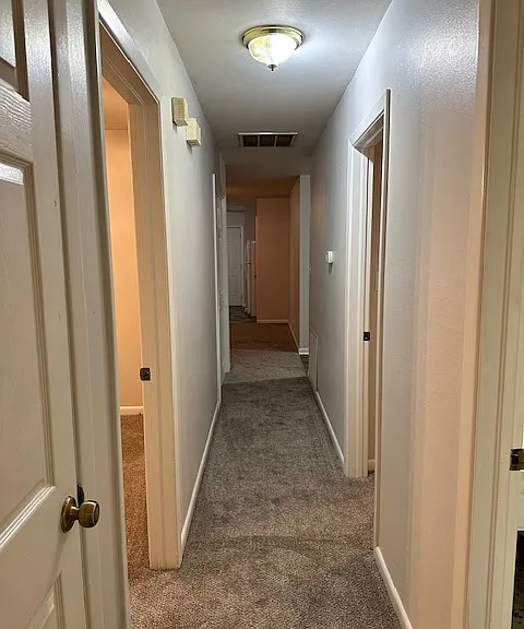 View from end of bedroom hallway toward dining room.