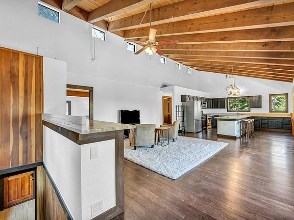 Grand entrance to open 750+sq ft living room with 20+ft vaulted ceilings