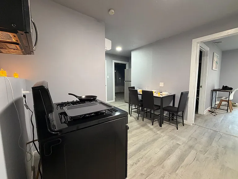 Open kitchen and dining area with a full-size range and dedicated table seating for shared meals and everyday use.