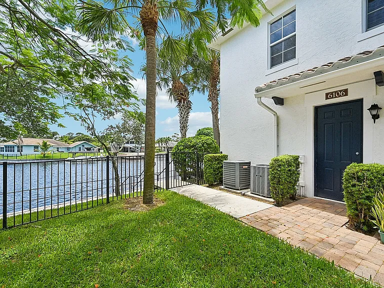 Waterfront townhomes with a lush garden, private entrance, and picturesque lake views.
