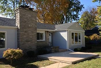 The home features a cozy front porch with room to plant flowers and greet guests.