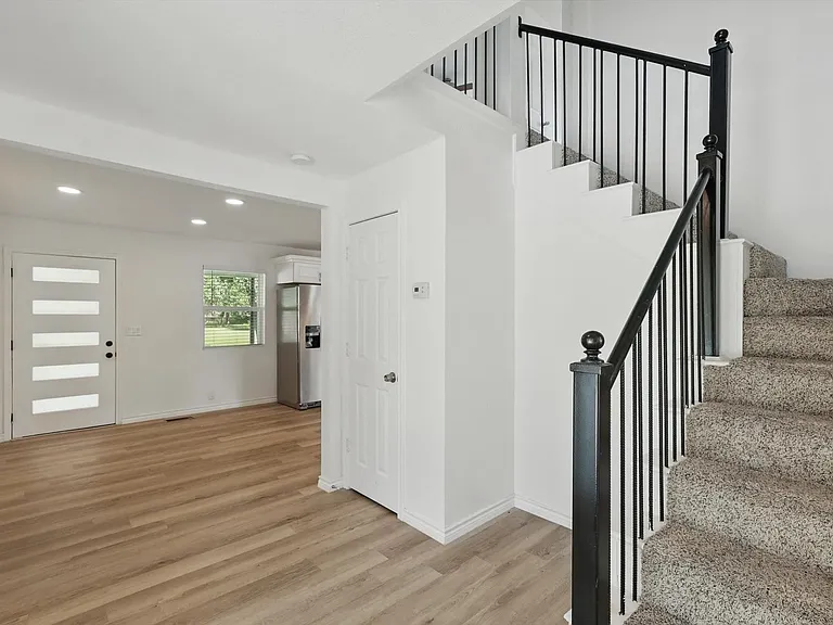 Staircase featuring wood finished floors, recessed lighting, and baseboards