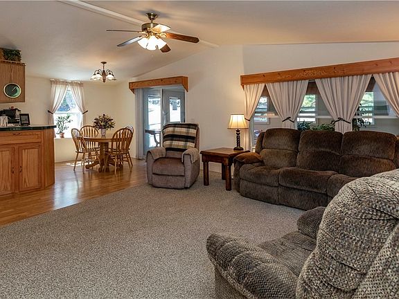 Looking back into the living room, kitchen and dinning. Double doors lead to sun room.