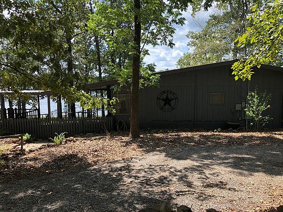 Main house with full kitchen, refrigerator, living, half bath, full bath off master bedroom. Beautiful cover side and back patio.