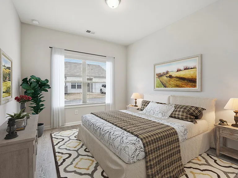 Secondary bedroom with queen size bed and large window letting in a ton of natural light.