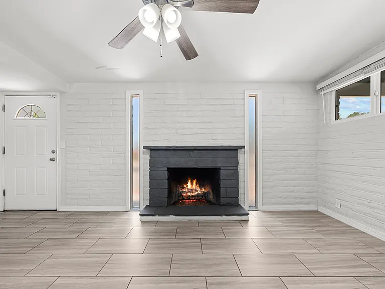 A cozy fireplace greets you just steps from the front door, perfect for relaxing evenings.