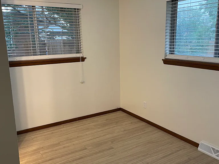 Smaller bedroom with half bath and new window shades.