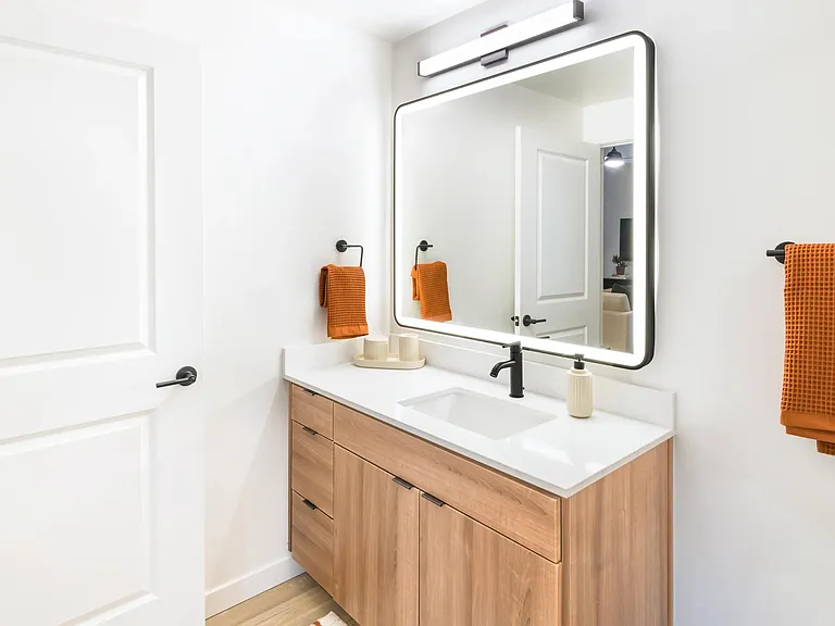 Refined finishes and warm tones create a polished retreat in every bathroom at Modera Higley Commons.