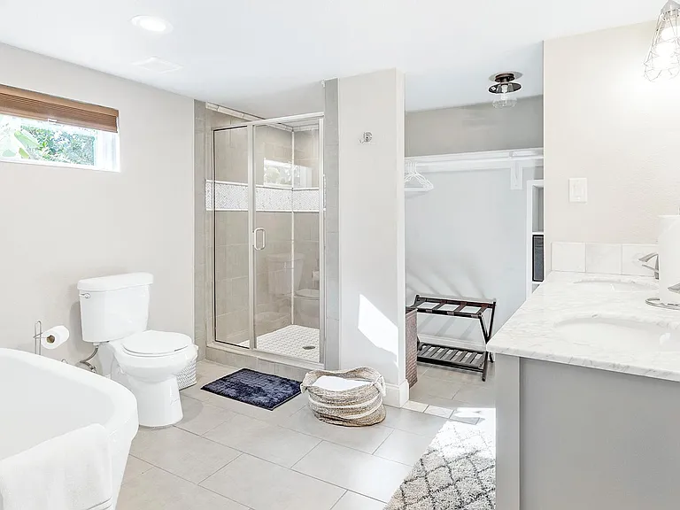 En-suite master bathroom with dual sink vanity walk-in shower, soaking tub, and closet