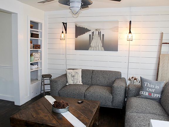 Cozy living space with a great built it and shiplap wall
