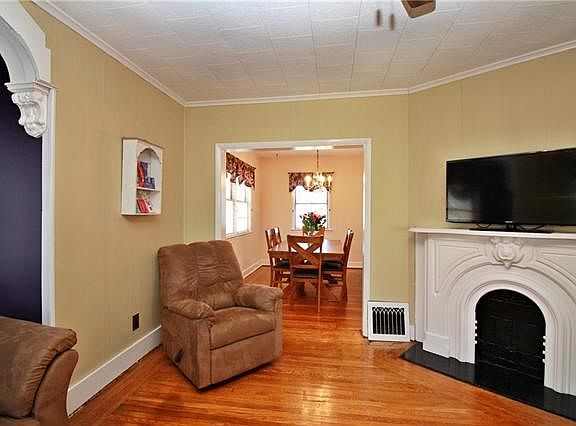 View from the living room into the formal dining room. Beautiful hardwood floors continue.