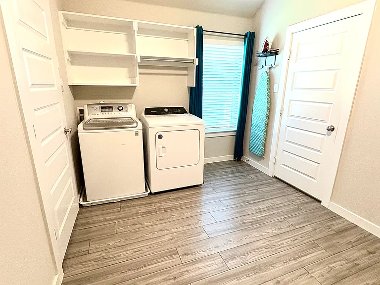 Laundry area & Study/Office/Craft Room with window & lighted ceiling fan.