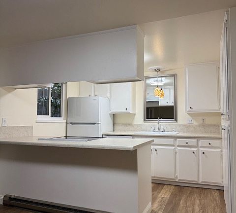 kitchen with new countertops, refrigerator, glass top range, dishwasher, large double cast iron sink